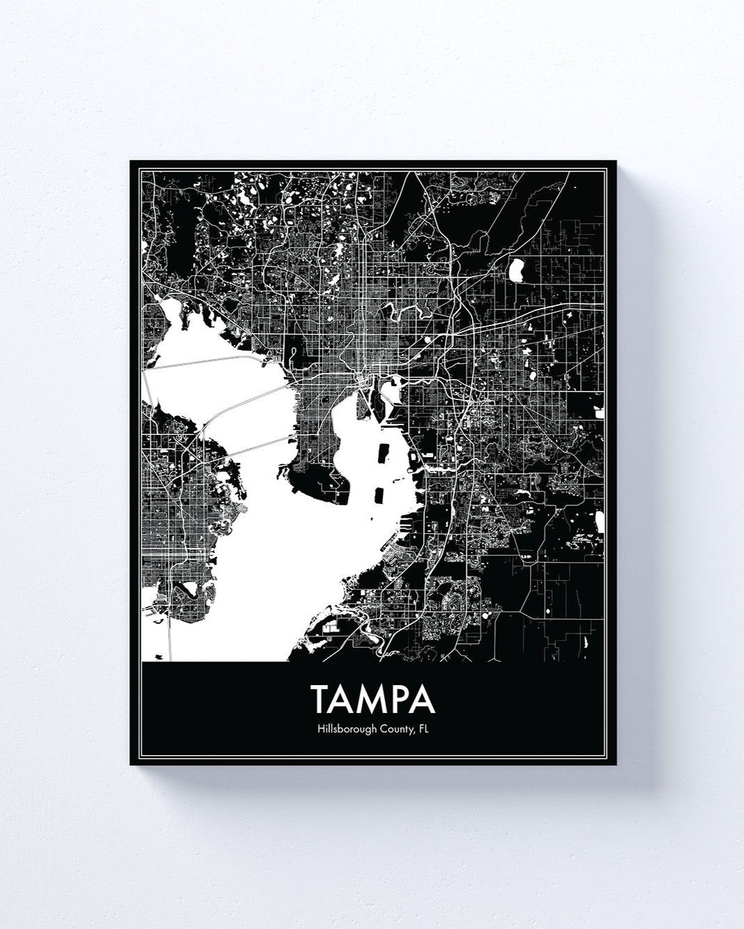 Framed black and white map of Tampa on a light gray background