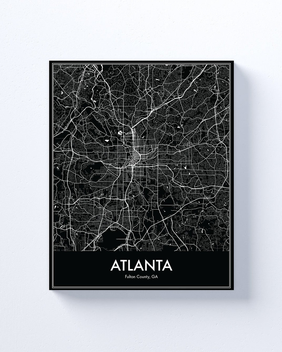 Framed black and white map of Atlanta on a light gray background